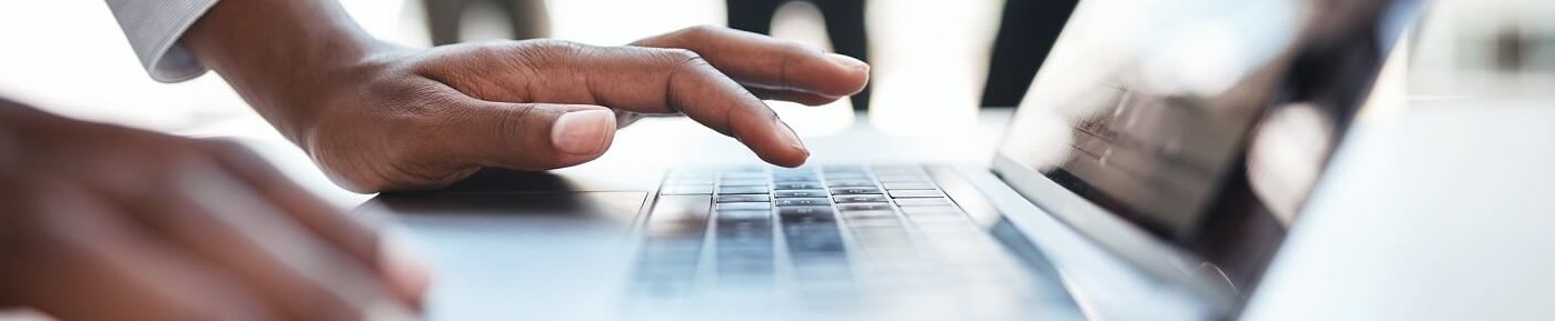 Image of hands typing on laptop computer.