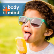 Young boy eating popsicle.