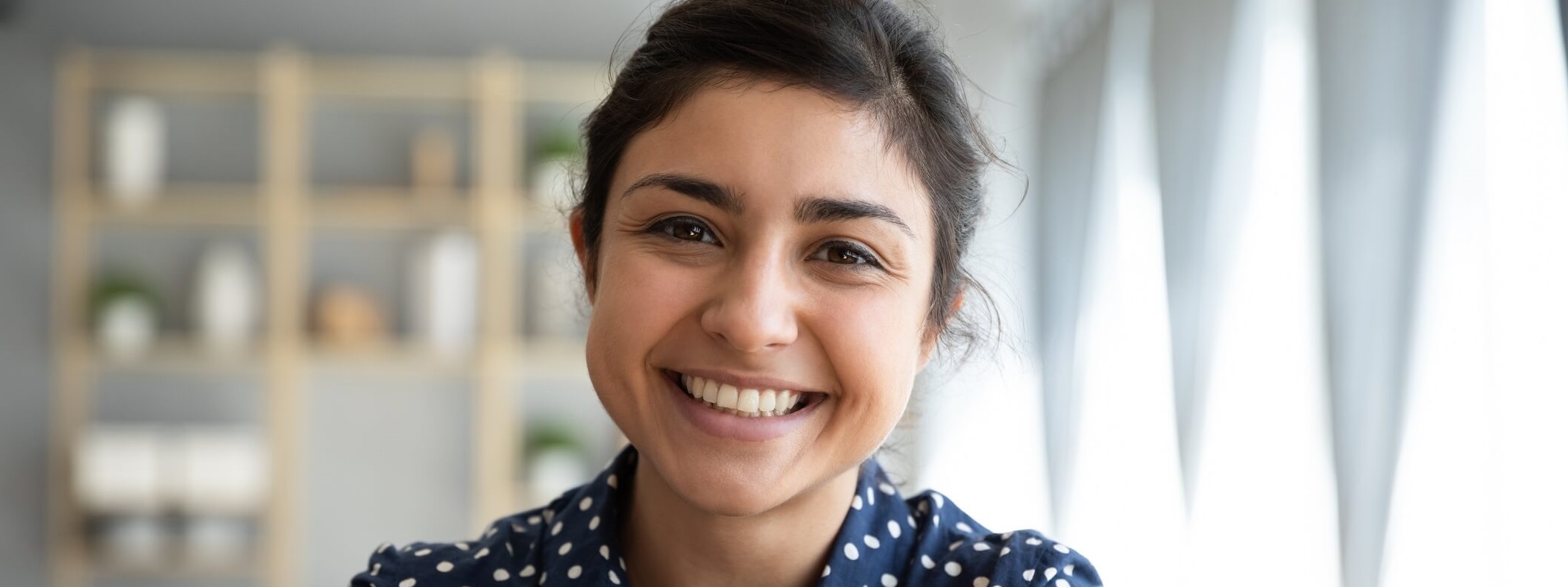 Smiling woman making direct eye contact.