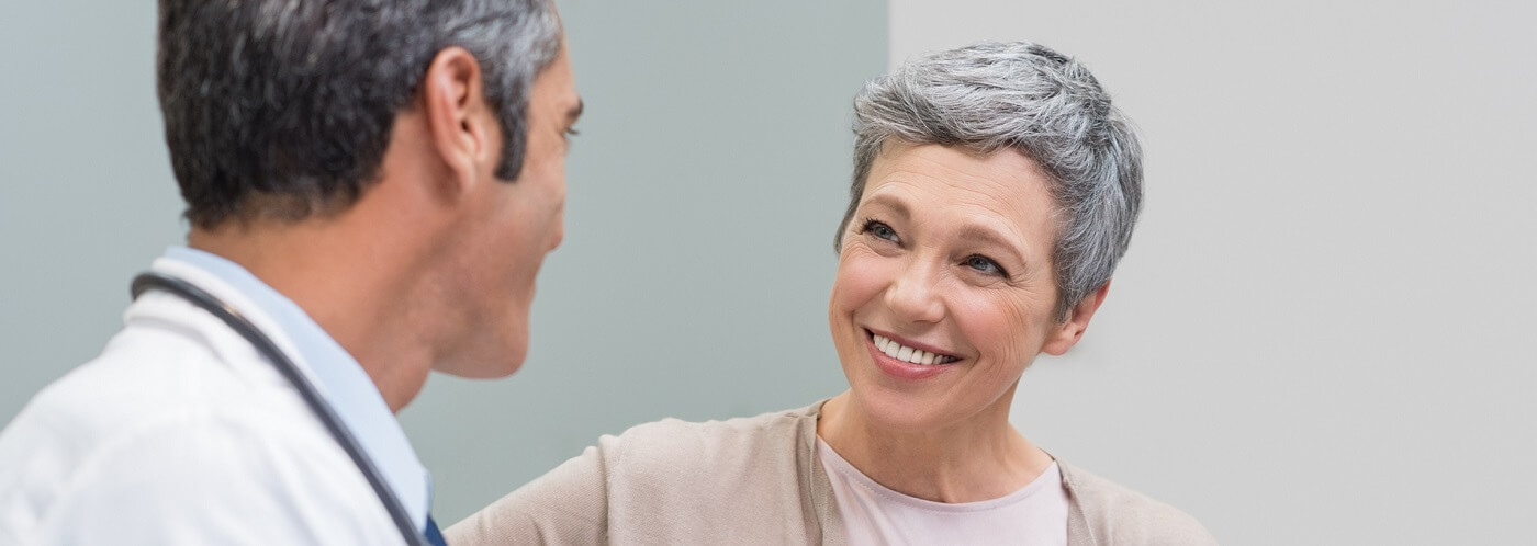Middle age woman talking with her physician.