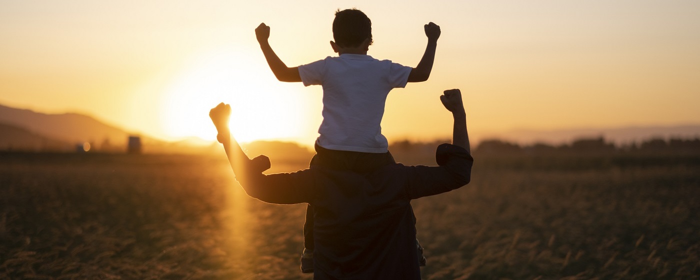 Boy riding on father's shoulders