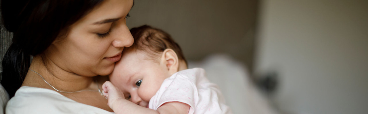 A mother embraces a newborn baby on her chest