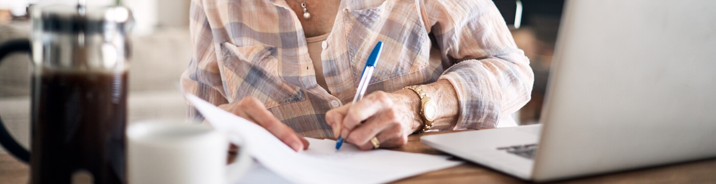 Photo of a woman filling out a survey.