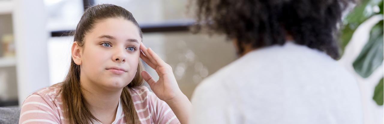 A young woman confides in a healthcare worker