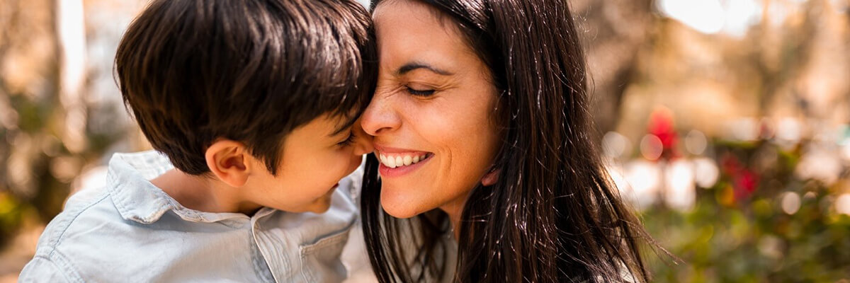 Young mom and son hugging.