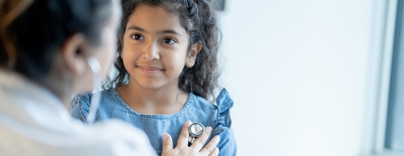 photo of little girl with provider at annual check up.