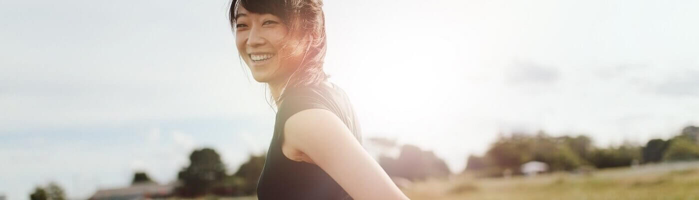 Photo of young woman walking outdoors.