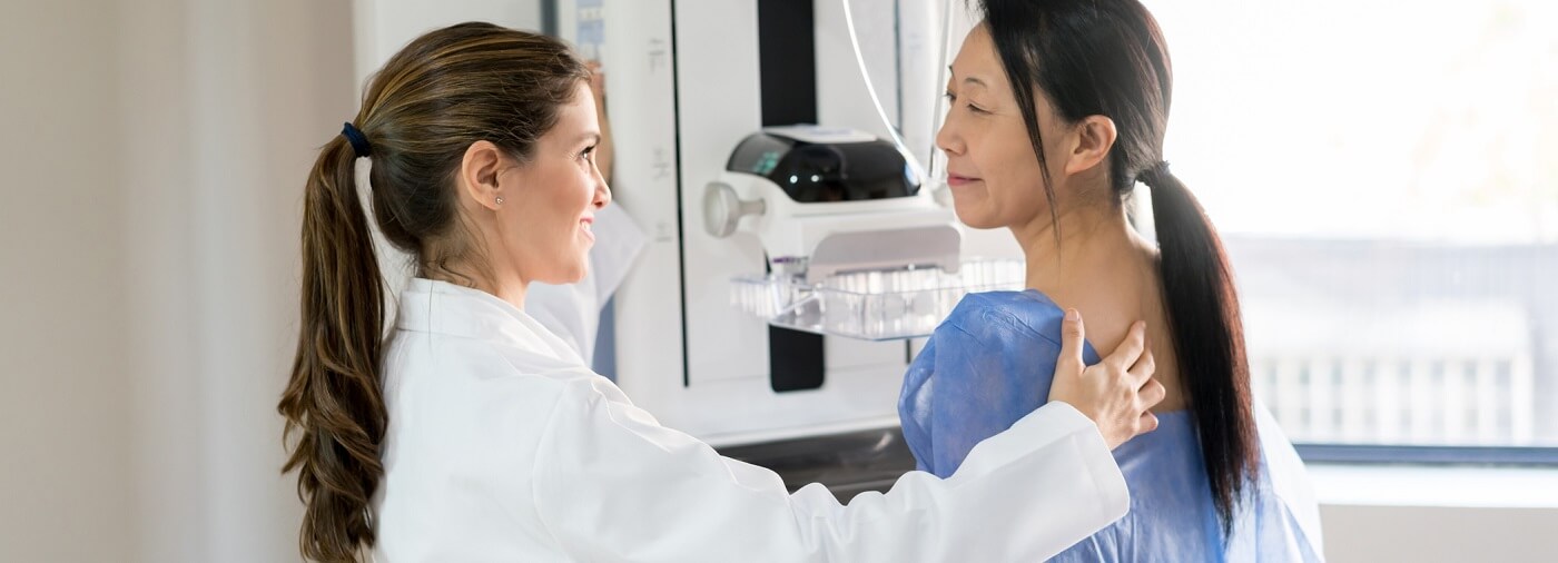 Woman in the process of getting a mammogram.