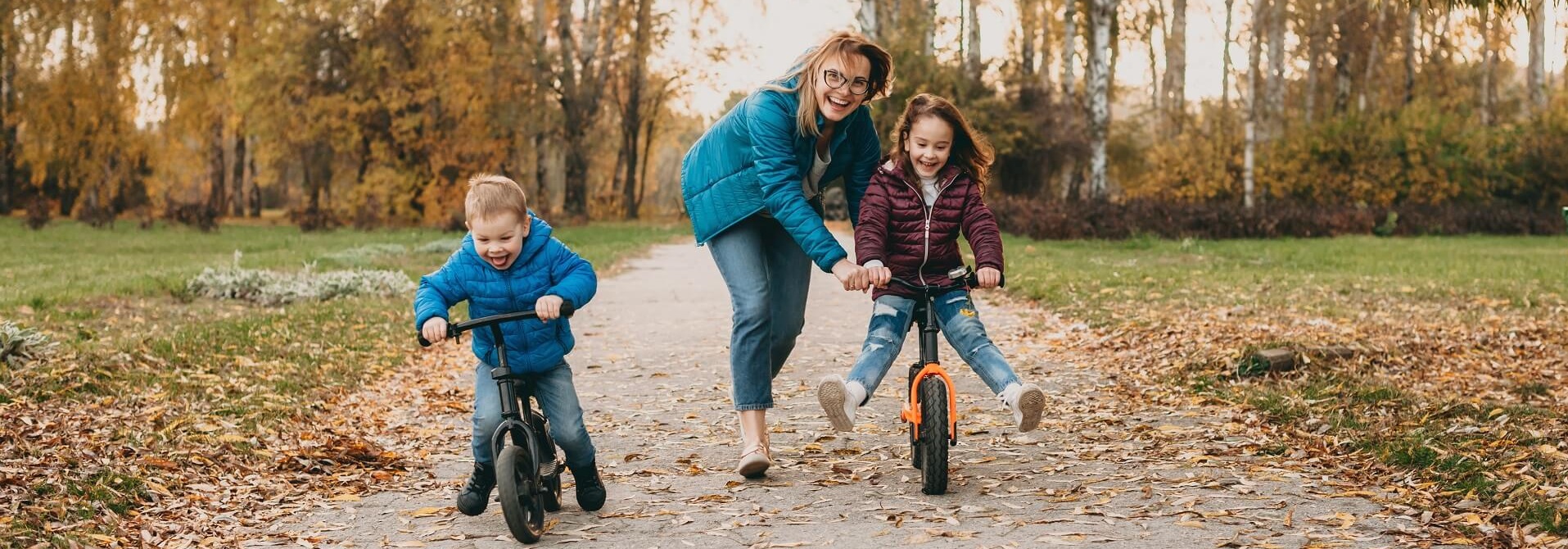 Photo of mom playing with kids in the park.