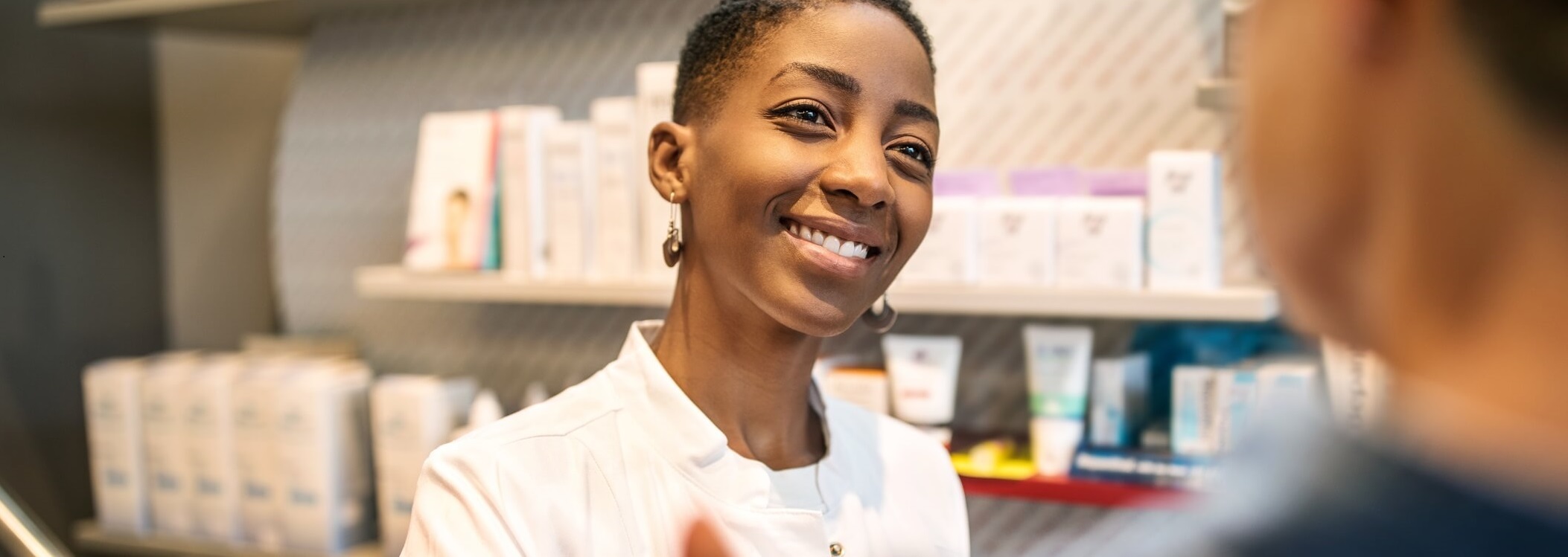 Photo of pharmacist explaining medication instructions.