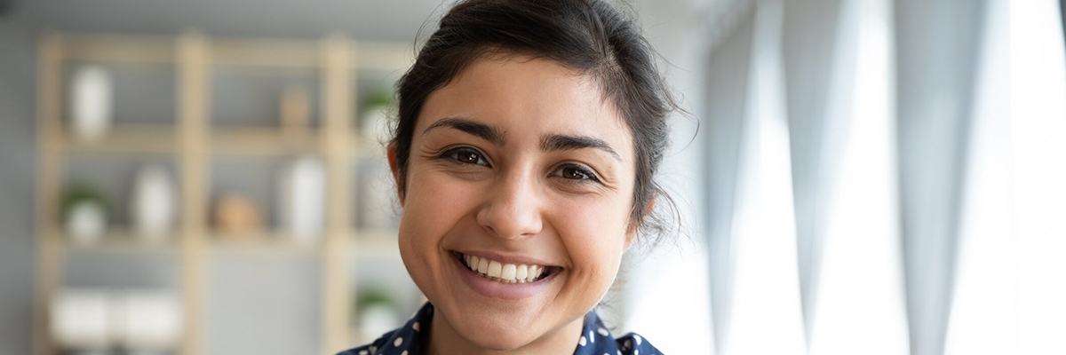 Smiling woman making direct eye contact.