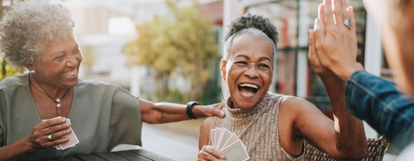 Women Playing Cards and Laughing