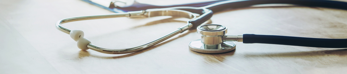 Photo of stethoscope laying on desk.