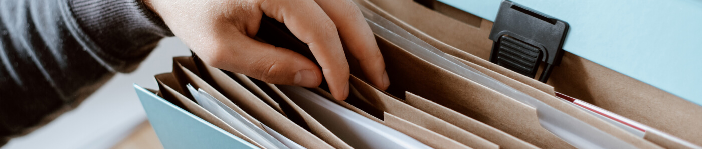 Person sorting through file of documents