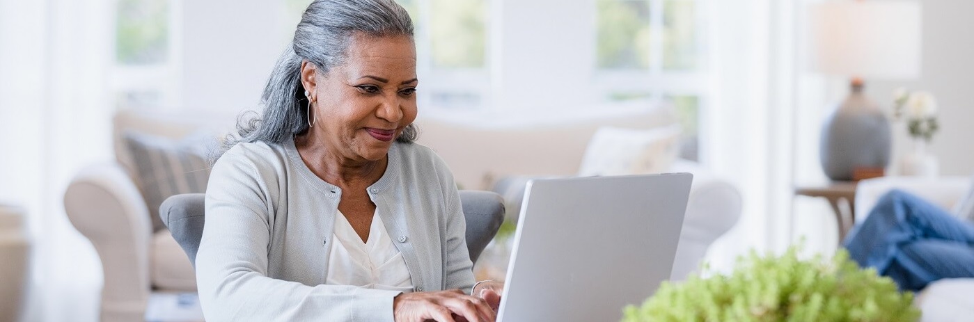 Woman looking at catalog on her laptop