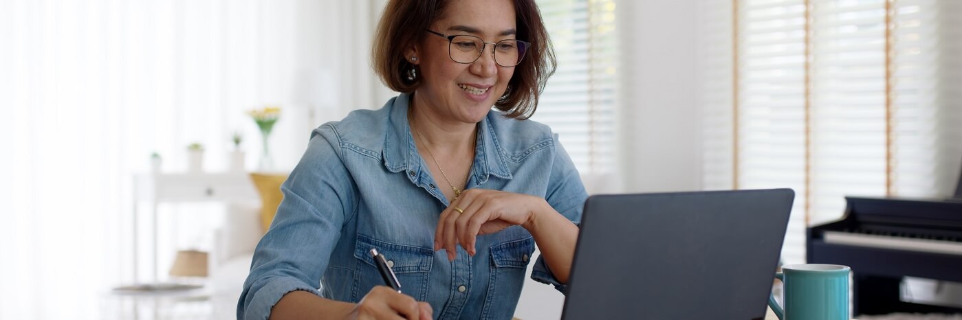 Woman using computer at home to look up health information.