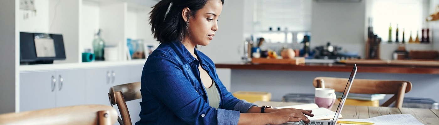 Young woman using laptop at home.