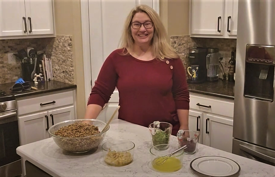 photo of woman making quinoa salad at home.
