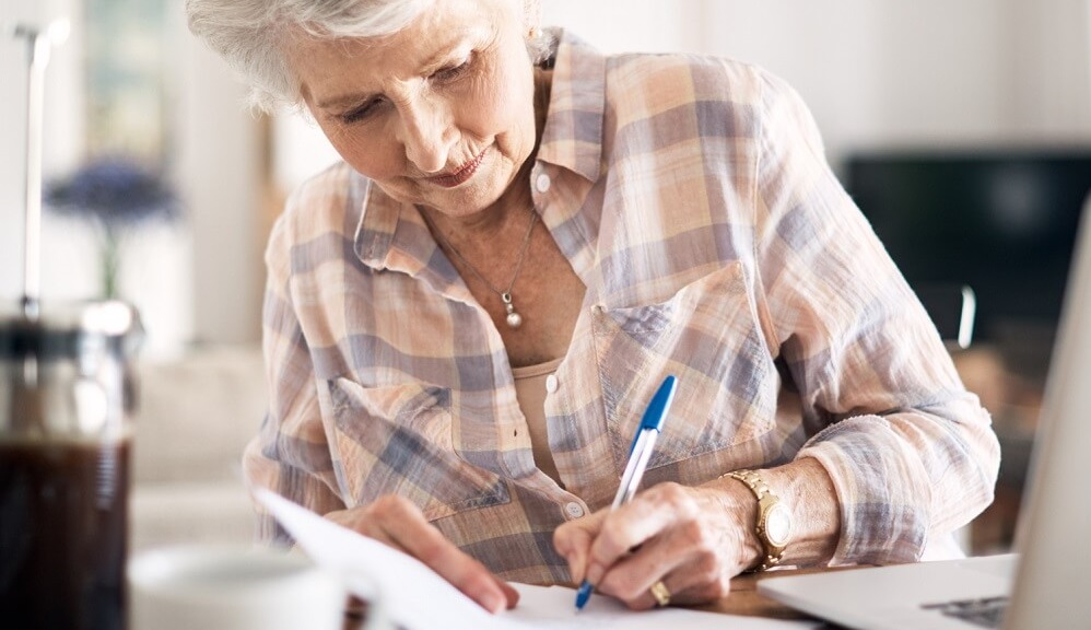 Photo of a woman filling out a survey.