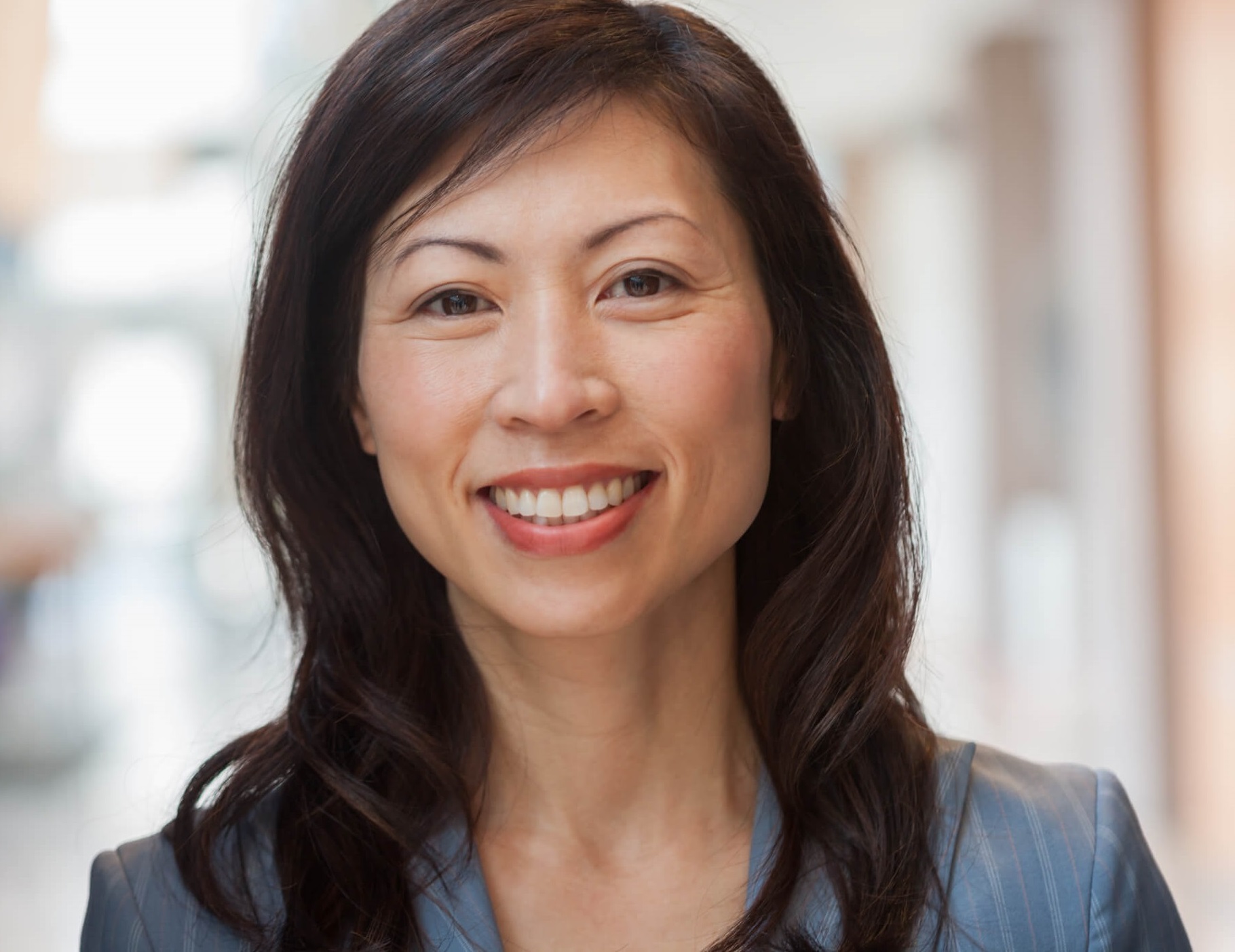 Photo of smiling, supportive, adult woman.