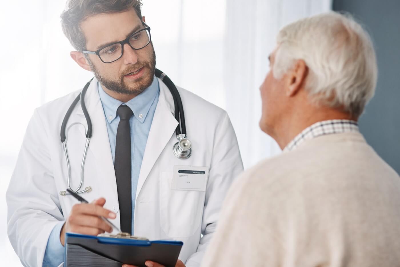 Photo of doctor talking intently with patient.