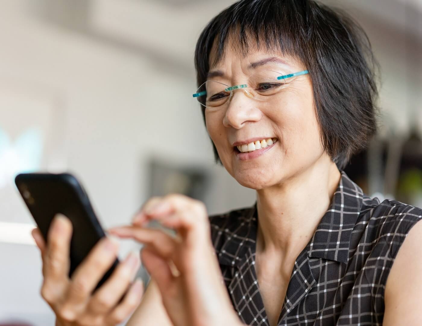 Photo of woman using MyDHMP app on cell phone.