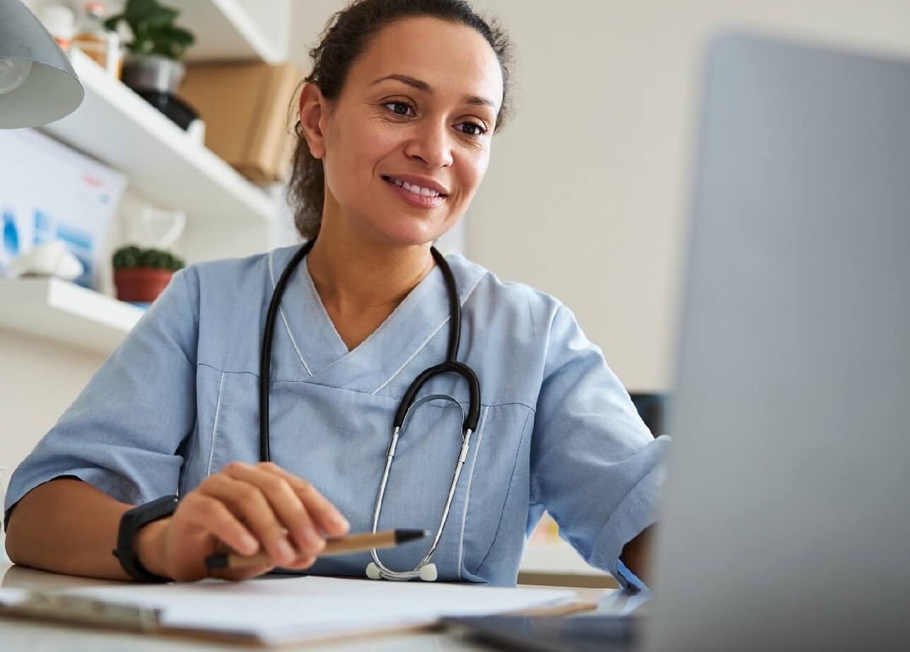 Photo of health care provider using laptop computer.