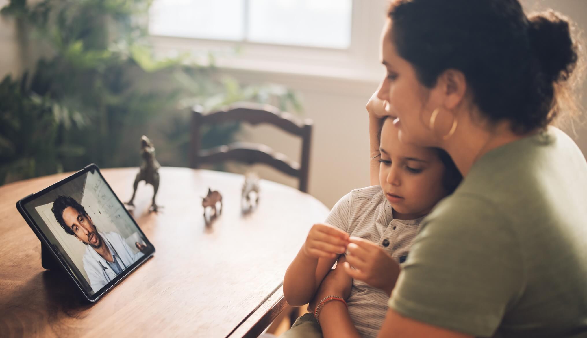 Woman and child doing video call with doctor.