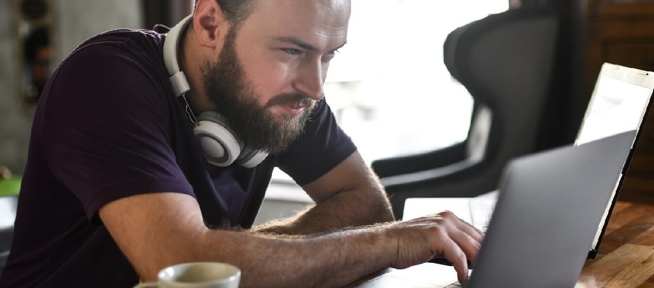 Man looking for information using his laptop
