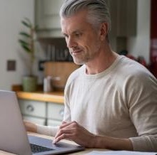 Man looking for information on laptop.