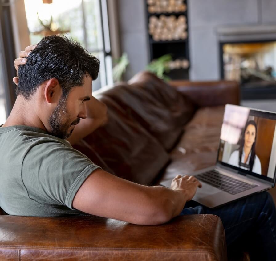 Man participating in telehealth therapy.