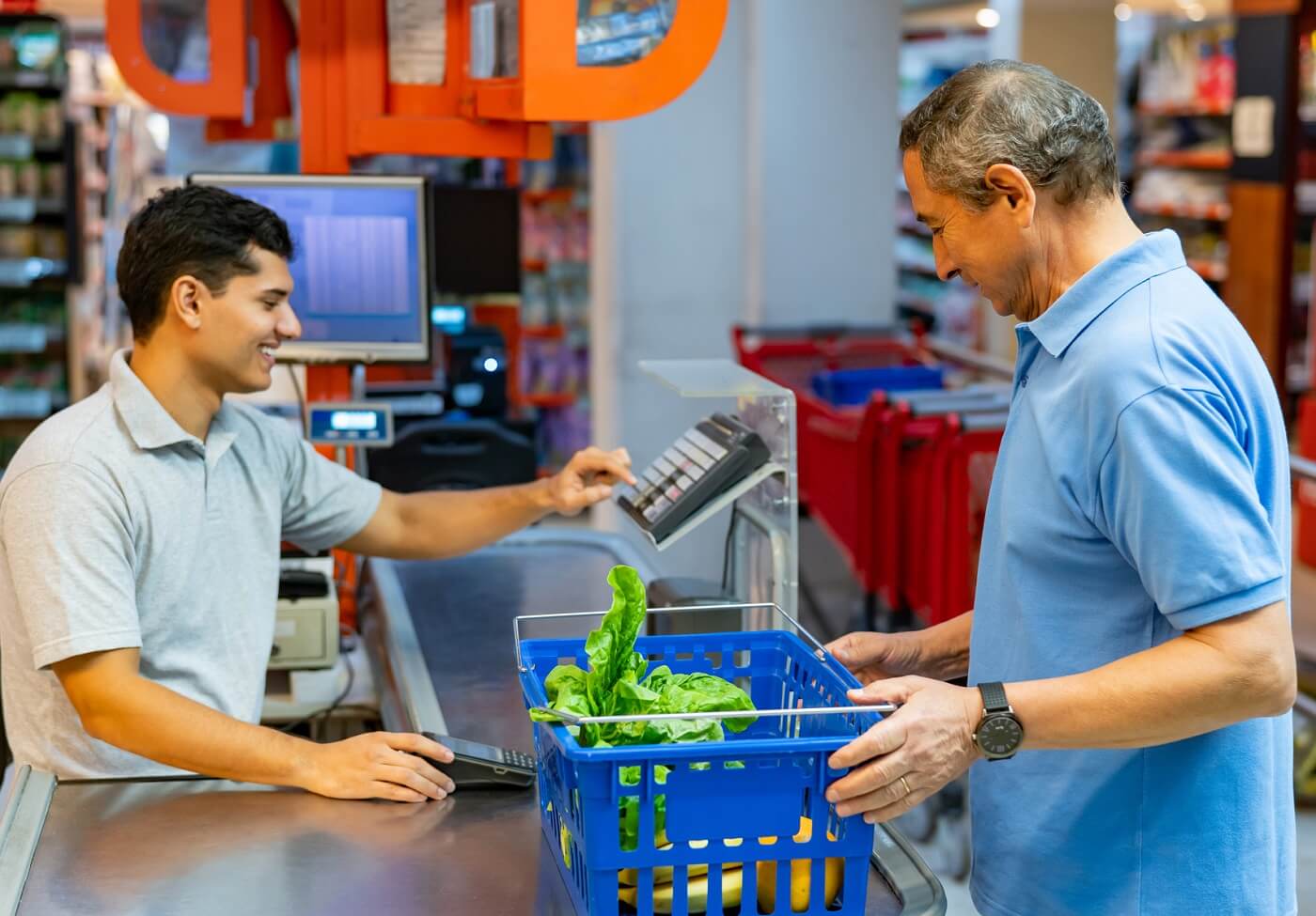 Photo of man at checkout counter purchasing food.