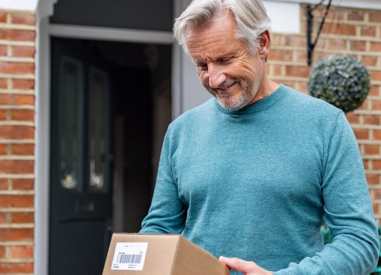 Photo of man receiving his prescriptions by mail.