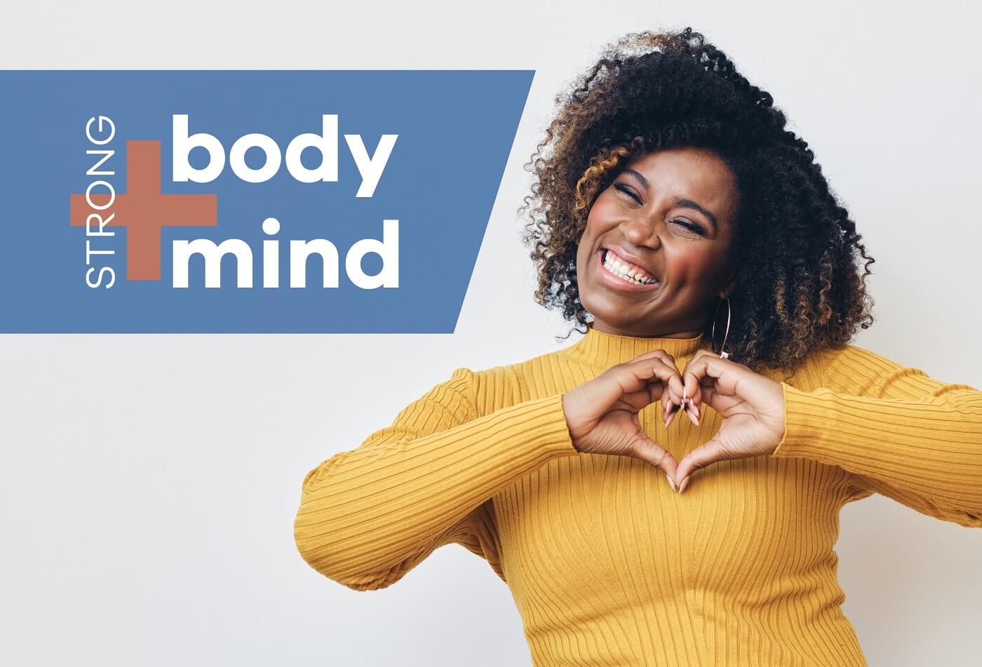 Smiling woman making heart shape with her hands.