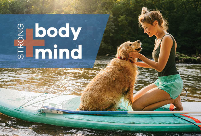 Image of woman with her dog at a lake