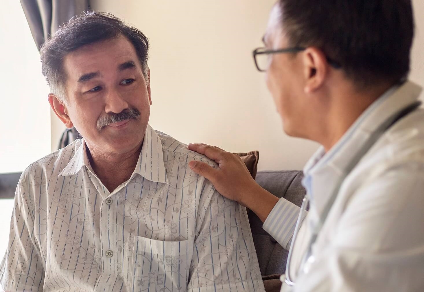 Photo of man talking with mental health provider.