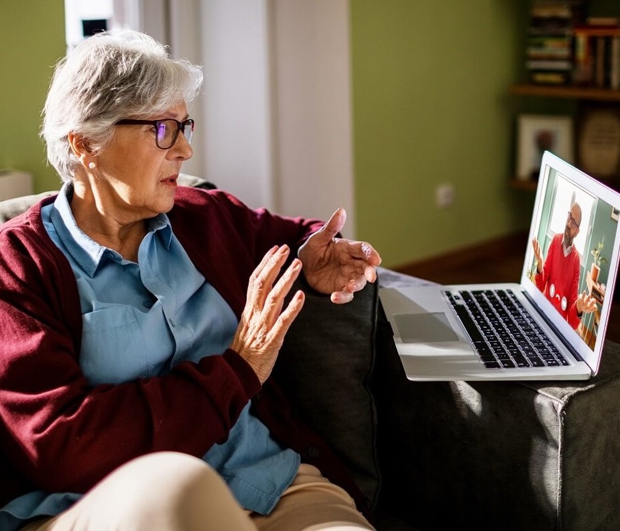 Photo of woman participating in telehealth mental health appointment.