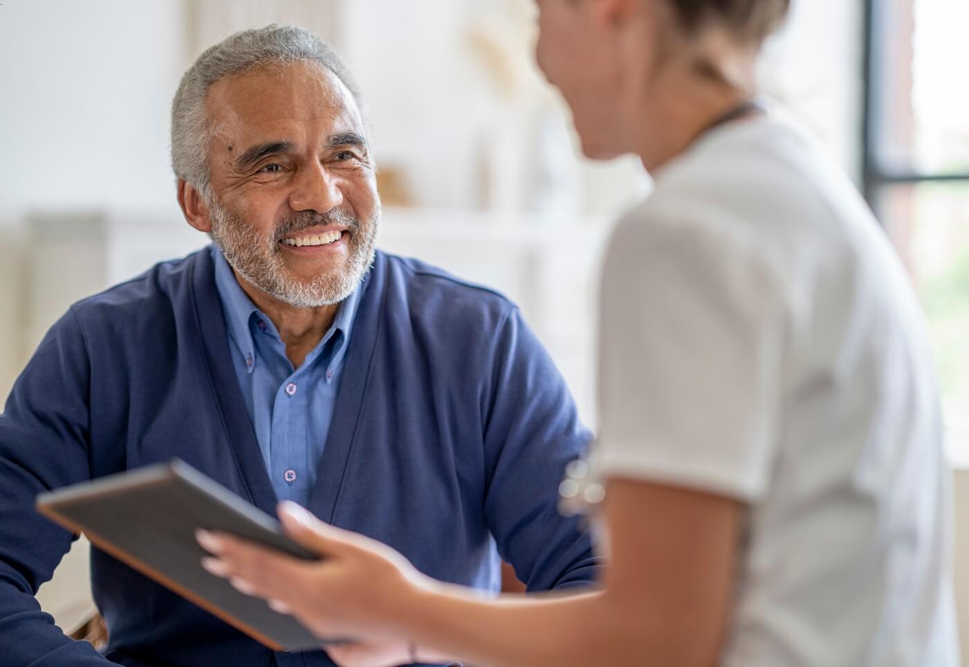 Senior man at appointment with health care provider.