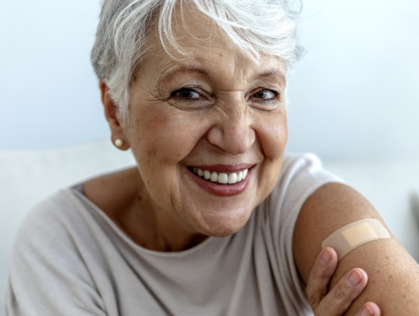 Photo of smiling woman showing that she got her vaccine.