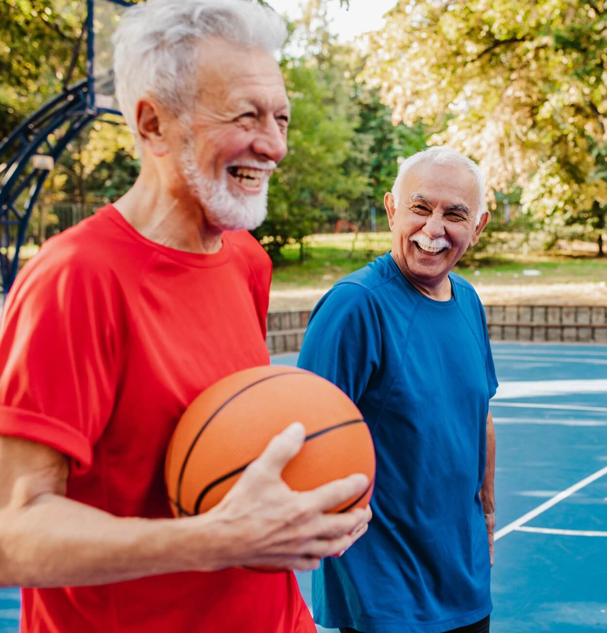 Senior men playing basketball