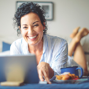 Woman reading wellness article on laptop.