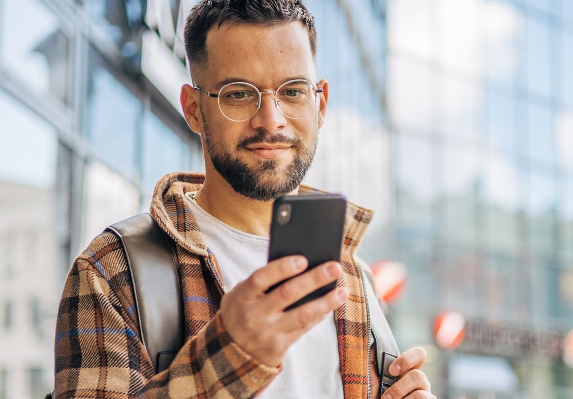 Young man downtown using smartphone