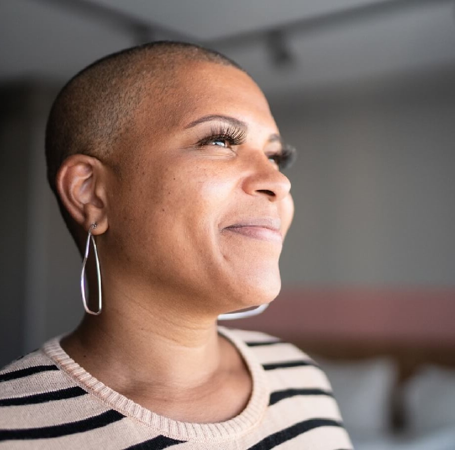 Photo of woman smiling and looking outward.