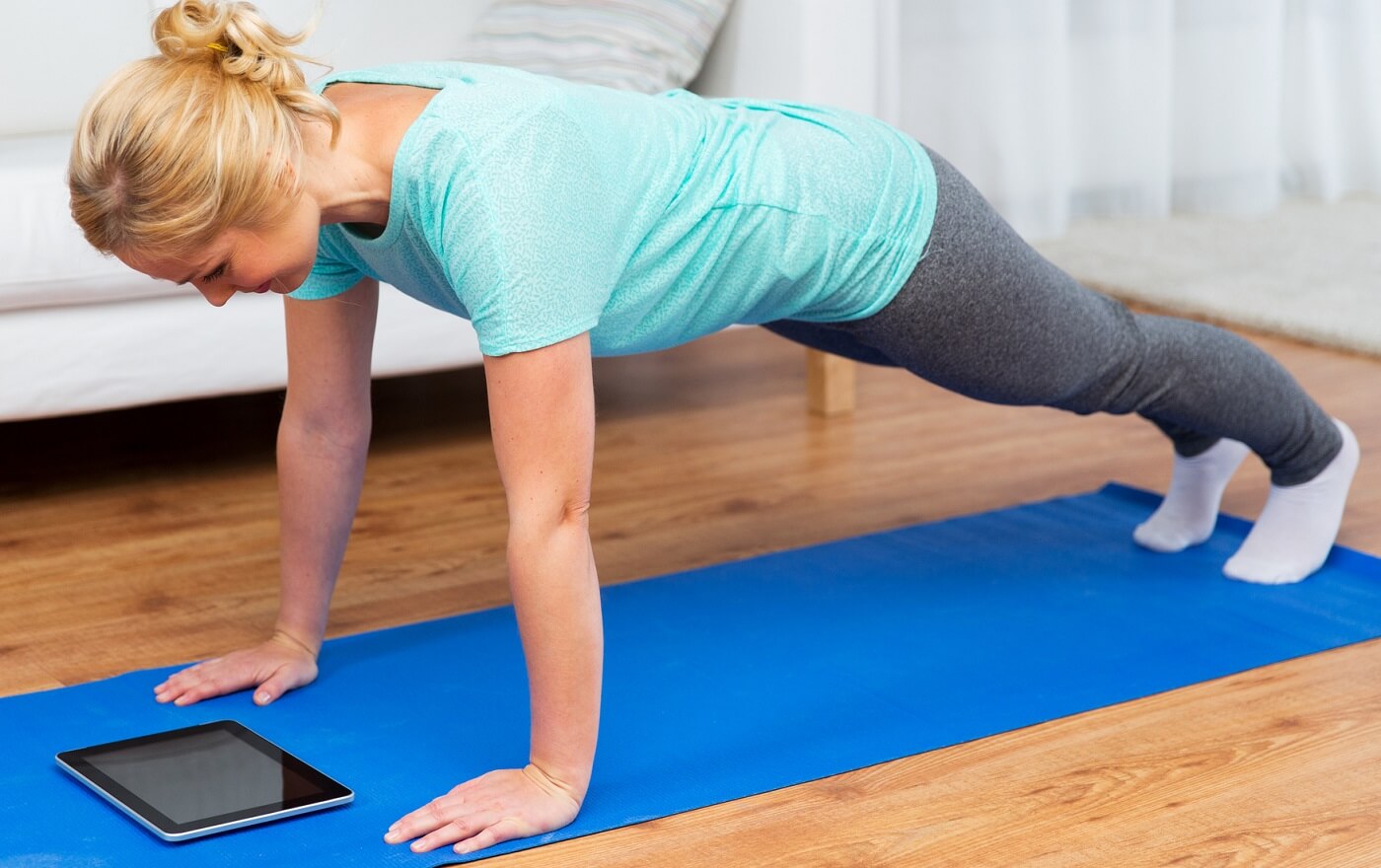 Woman exercising with tablet.