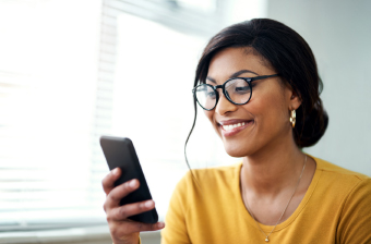 a woman checks her smart phone