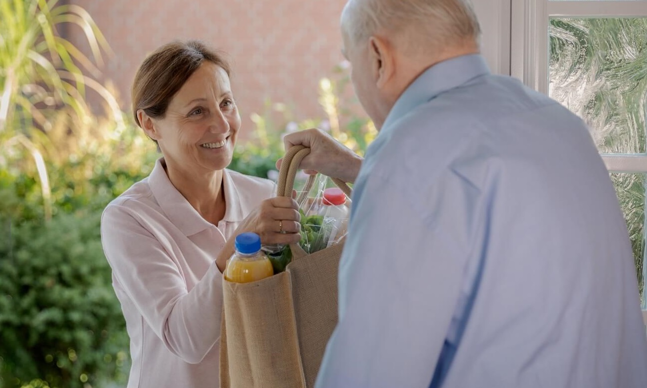 senior man getting food delivered.