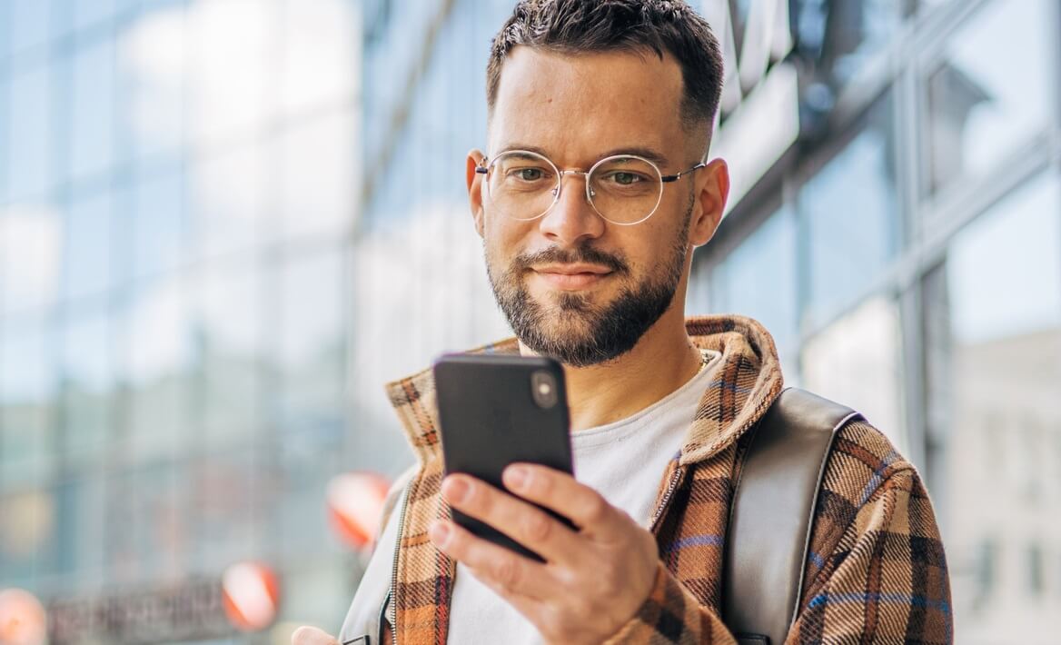Young man downtown using smartphone