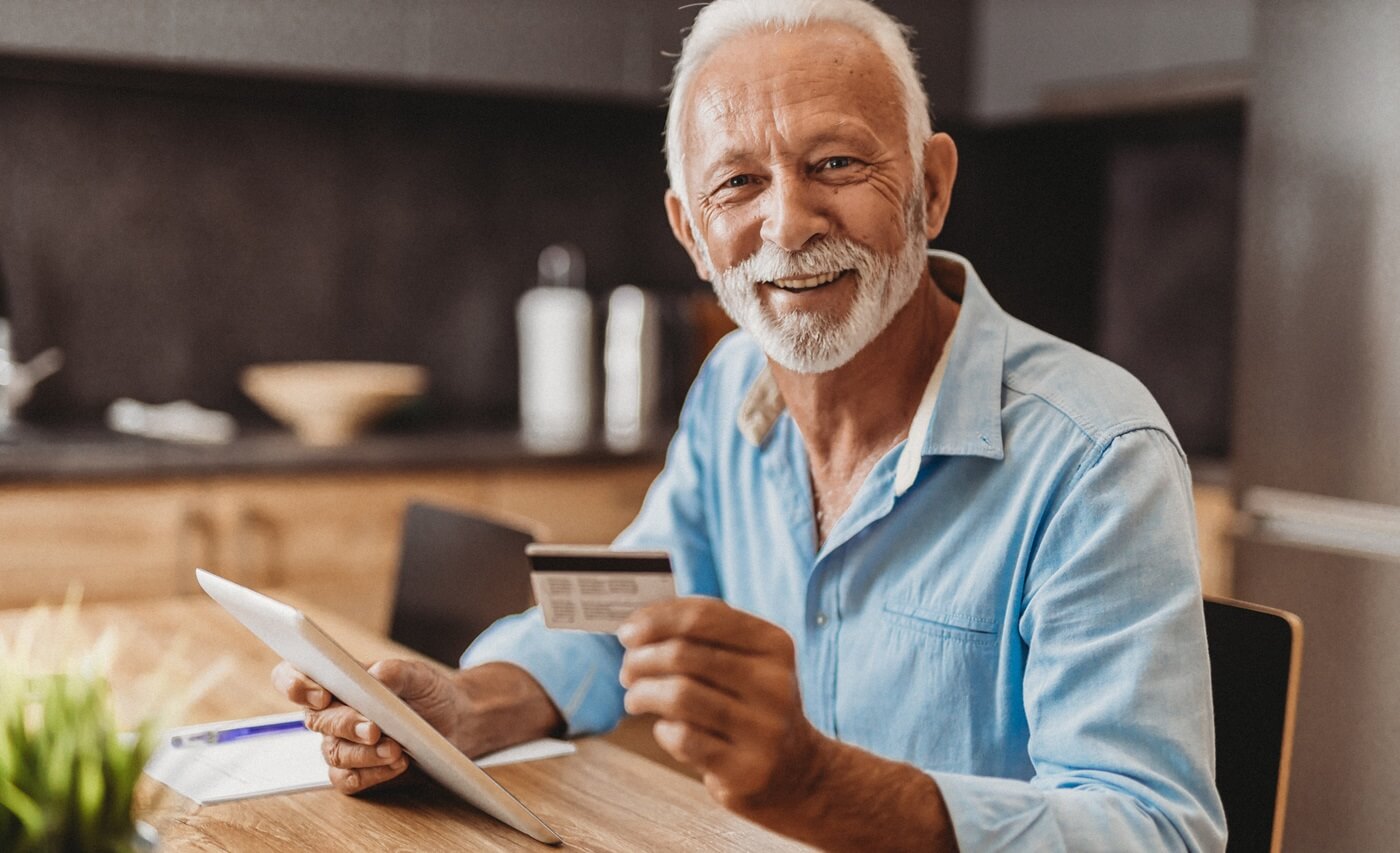 Happy senior man making a purchase using his FlexCard.
