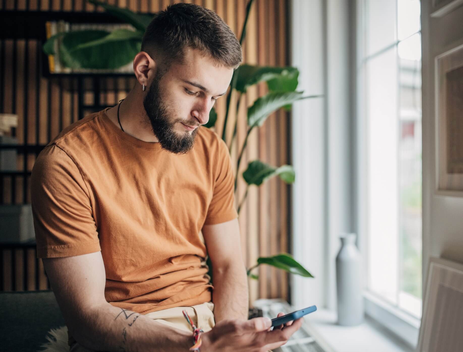 Man looking for information on mobile phone.