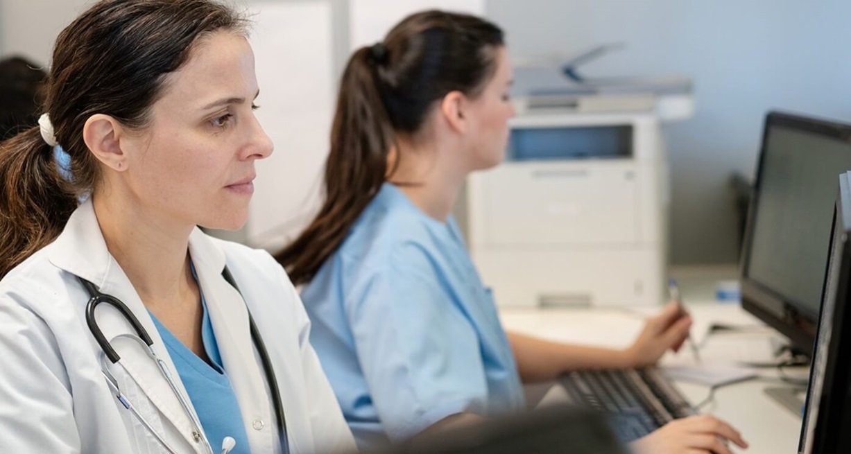 Provider office staff member working at computer.